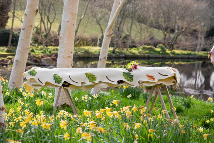 Leaf style felt shroud by Bellacouche in a field of daffodils